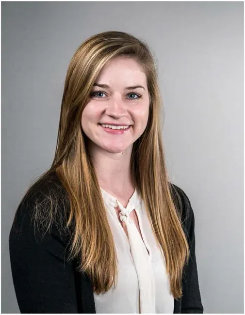 Corporate headshot on a plain white or gray background, selection 2