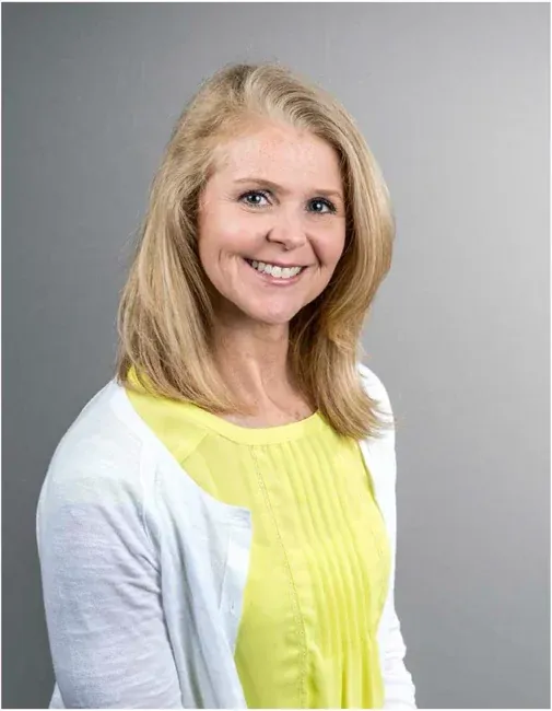 Corporate headshot on a plain white or gray background, selection 7