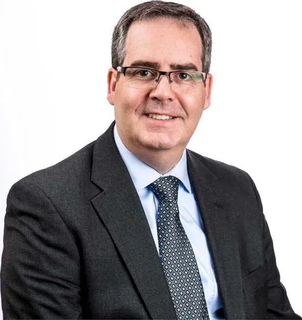 Corporate headshot on a plain white or gray background, selection 5