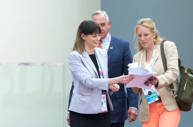 World Gas Conference — Attendees reviewing materials in a bright exhibition space