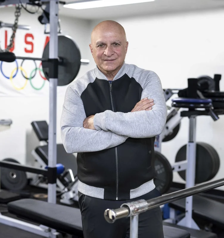 Environmental portrait of a man standing in a gym