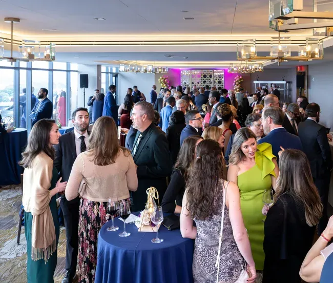 A wide view of guests mingling at the ASE 2026 reception