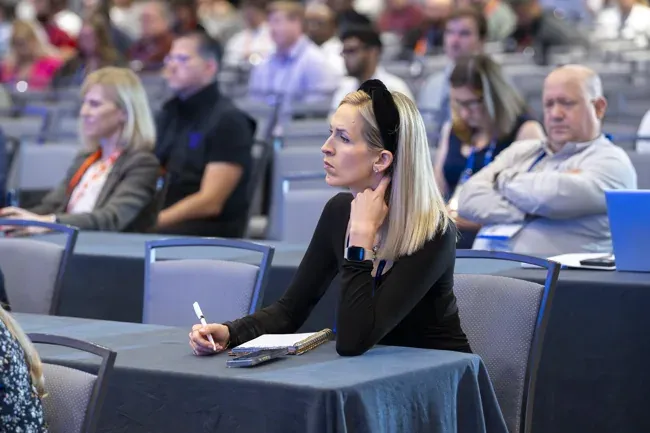 Merchant Advisory Group — Attendee taking notes during a session